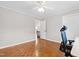 Parquet floor in bedroom with a ceiling fan, desk and chair with hallway view at 3716 Yorktown Pl, Raleigh, NC 27609