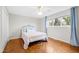 Cozy bedroom featuring a comfortable bed, a large window, and a light, airy color scheme at 3716 Yorktown Pl, Raleigh, NC 27609
