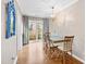 Bright dining room featuring a glass table, stylish chairs, chandelier and access to the backyard at 3716 Yorktown Pl, Raleigh, NC 27609