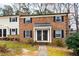 Traditional brick townhouse with black shutters and a covered entryway, set in a well-maintained community at 3716 Yorktown Pl, Raleigh, NC 27609