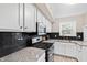 Well-appointed kitchen featuring white cabinets, granite countertops, and stainless steel appliances for a modern feel at 3716 Yorktown Pl, Raleigh, NC 27609
