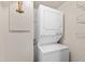 Laundry room with stacked washer and dryer units, maximizing space and providing convenience for homeowners at 3716 Yorktown Pl, Raleigh, NC 27609