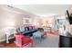 Inviting living room featuring a plush green sofa, stylish decor, and a bright, airy atmosphere at 3716 Yorktown Pl, Raleigh, NC 27609