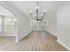 Bright dining room area with modern chandelier, large windows, and open floor plan at 376 Buckhorn Branch Park # 38, Clayton, NC 27520