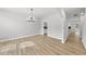 Bright, airy dining room featuring wood floors and a modern chandelier, adjacent to the kitchen area at 376 Buckhorn Branch Park # 38, Clayton, NC 27520