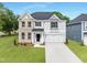 Charming two-story home featuring a brick and siding exterior, a well-manicured lawn, and an attached two-car garage at 376 Buckhorn Branch Park # 38, Clayton, NC 27520