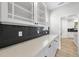 Close-up of a kitchen counter with white cabinets, quartz countertops, and a stylish black tile backsplash at 376 Buckhorn Branch Park # 38, Clayton, NC 27520