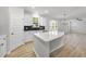 Open kitchen with quartz island overlooking the breakfast area featuring stainless steel appliances and white cabinets at 376 Buckhorn Branch Park # 38, Clayton, NC 27520