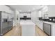 Spacious kitchen featuring white cabinets, stainless steel appliances, and a center island with quartz countertops at 376 Buckhorn Branch Park # 38, Clayton, NC 27520