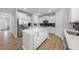Modern kitchen featuring white cabinets, stainless steel appliances, and a spacious island with quartz countertops at 376 Buckhorn Branch Park # 38, Clayton, NC 27520