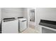 Functional laundry room with washer, dryer, counter space, and hallway access at 376 Buckhorn Branch Park # 38, Clayton, NC 27520