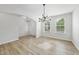 Inviting living room with natural light, featuring wood floors and modern lighting fixtures near the front entry at 376 Buckhorn Branch Park # 38, Clayton, NC 27520