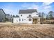 Back of a two-story home featuring a wooden porch overlooking the spacious backyard at 3812 Cobbler View Way, Fuquay Varina, NC 27526