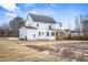 Back view of a two-story home with a covered wooden porch and spacious yard at 3812 Cobbler View Way, Fuquay Varina, NC 27526