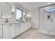 Modern bathroom features a double vanity, sleek mirrors, and a luxurious glass-enclosed shower at 3812 Cobbler View Way, Fuquay Varina, NC 27526