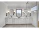 Bright bathroom features a double vanity, decorative mirrors, and a glass-enclosed shower at 3812 Cobbler View Way, Fuquay Varina, NC 27526