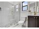 Modern bathroom with a glass-enclosed shower, mosaic tile floor, dark vanity, and gold fixtures at 3812 Cobbler View Way, Fuquay Varina, NC 27526