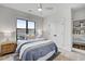 Comfortable bedroom with a large window, a ceiling fan, and a stylish blue comforter set at 3812 Cobbler View Way, Fuquay Varina, NC 27526
