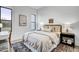 This bedroom features neutral decor, carpet, a ceiling fan, and a large window with natural light at 3812 Cobbler View Way, Fuquay Varina, NC 27526