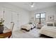 Bright bedroom features two beds, a ceiling fan, and a large window, creating a comfortable and inviting space at 3812 Cobbler View Way, Fuquay Varina, NC 27526