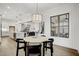 Open concept eat-in kitchen/dining area and living room with hardwood flooring and neutral paint at 3812 Cobbler View Way, Fuquay Varina, NC 27526