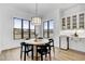 Bright dining area featuring a modern light fixture, round table with seating, and built-in cabinets at 3812 Cobbler View Way, Fuquay Varina, NC 27526