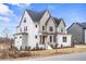 Side view of a striking two-story home featuring white brick and complementary trim at 3812 Cobbler View Way, Fuquay Varina, NC 27526