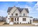 Stunning two-story home with white brick, accented by wooden trim and beautiful landscaping at 3812 Cobbler View Way, Fuquay Varina, NC 27526
