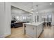 Spacious kitchen island with seating that opens to a living room with fireplace and backyard view at 3812 Cobbler View Way, Fuquay Varina, NC 27526