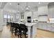 Bright kitchen features a large center island with seating, modern appliances, and stylish pendant lighting at 3812 Cobbler View Way, Fuquay Varina, NC 27526