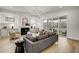 Spacious living room with fireplace, built-in cabinets, and access to an outdoor patio at 3812 Cobbler View Way, Fuquay Varina, NC 27526