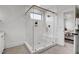 Luxurious glass-enclosed shower with marble tile, built-in shelving, and modern fixtures at 3812 Cobbler View Way, Fuquay Varina, NC 27526