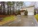 An outdoor patio area with a small pergola, set in a sprawling backyard with surrounding lush trees at 4102 Panther Creek Pkwy, Durham, NC 27704