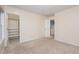 A clean, carpeted bedroom offering natural light and featuring a convenient walk-in closet for ample storage at 4102 Panther Creek Pkwy, Durham, NC 27704