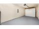 This is a large garage area with smooth painted floors, an electrical box and a white garage door at 4102 Panther Creek Pkwy, Durham, NC 27704
