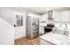 Modern kitchen with stainless steel appliances, white cabinets, and granite countertops at 4102 Panther Creek Pkwy, Durham, NC 27704