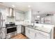 Bright kitchen featuring white cabinets, stainless appliances, granite countertops and subway tile backsplash at 4102 Panther Creek Pkwy, Durham, NC 27704