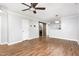 Bright living room featuring fresh neutral paint, a ceiling fan, hardwood floors and a sliding barn door at 4102 Panther Creek Pkwy, Durham, NC 27704