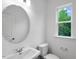 Well lit bathroom with a vessel sink, modern fixtures and a sunlit window at 427 Rowe Way, Knightdale, NC 27545