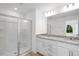 Modern bathroom featuring a large walk-in shower, double sink granite vanity and bright lighting at 427 Rowe Way, Knightdale, NC 27545