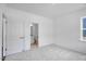 Bright bedroom features neutral carpet, white walls, and an ensuite bathroom providing comfort and privacy at 427 Rowe Way, Knightdale, NC 27545