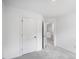 This bedroom offers neutral carpet, white walls, and easy access to an upper level and closet at 427 Rowe Way, Knightdale, NC 27545