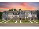 New townhomes showcasing craftsman style architecture, complemented by well-manicured lawns and vibrant landscaping at 427 Rowe Way, Knightdale, NC 27545