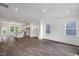 Spacious open-concept living room, kitchen and dining space with modern dark wood laminate flooring at 427 Rowe Way, Knightdale, NC 27545