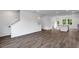 Spacious open-concept living room, kitchen and dining space with modern dark wood laminate flooring at 427 Rowe Way, Knightdale, NC 27545