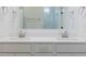Contemporary bathroom with double sinks, light gray cabinets, modern fixtures, and a mirror at 428 Hampshire Ct, Four Oaks, NC 27524