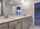 Bathroom with a large mirror and double sink vanity with white counter tops at 428 Hampshire Ct, Four Oaks, NC 27524