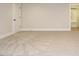 Spacious bedroom with plush carpeting and closet entrance at 428 Hampshire Ct, Four Oaks, NC 27524