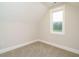 Bedroom with a window overlooking trees, neutral paint and carpeted flooring at 428 Hampshire Ct, Four Oaks, NC 27524