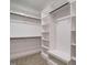 Organized walk-in closet with shelving, hanging rods, and neutral carpet flooring at 428 Hampshire Ct, Four Oaks, NC 27524